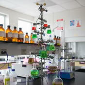 Holiday tree made of beakers and flasks filled with green- and red-colored liquids