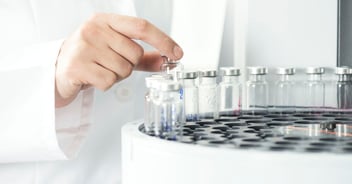 Scientist operating a centrifuge