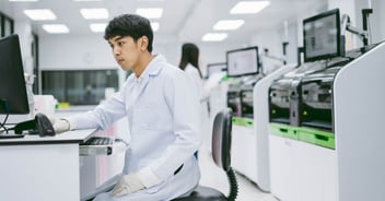 Scientist at computer in lab