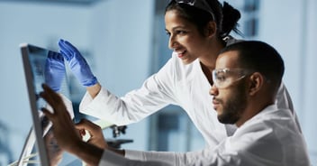 Science colleagues reviewing data on computer