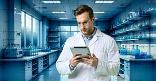 Scientist reviewing procurement business case on tablet computer
