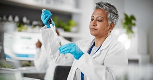 Scientist pipetting into test tube