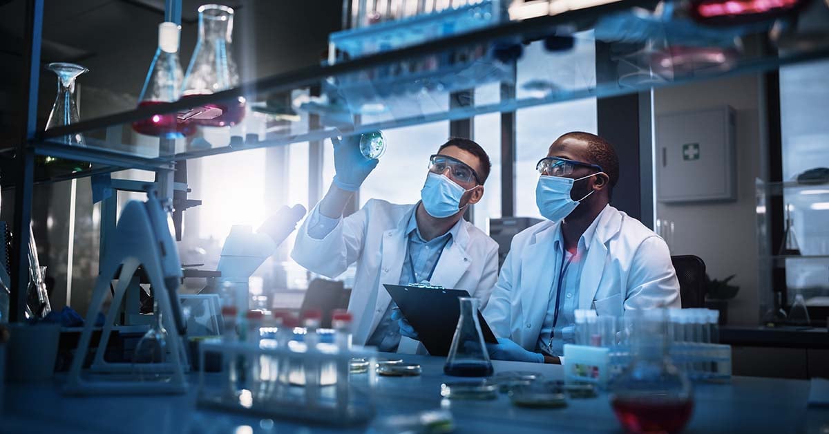 Scientists collaborating at a lab bench