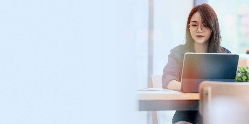Person sitting at desk watching a webinar on laptop