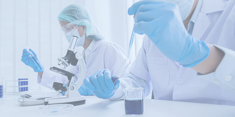 Two scientists working at bench