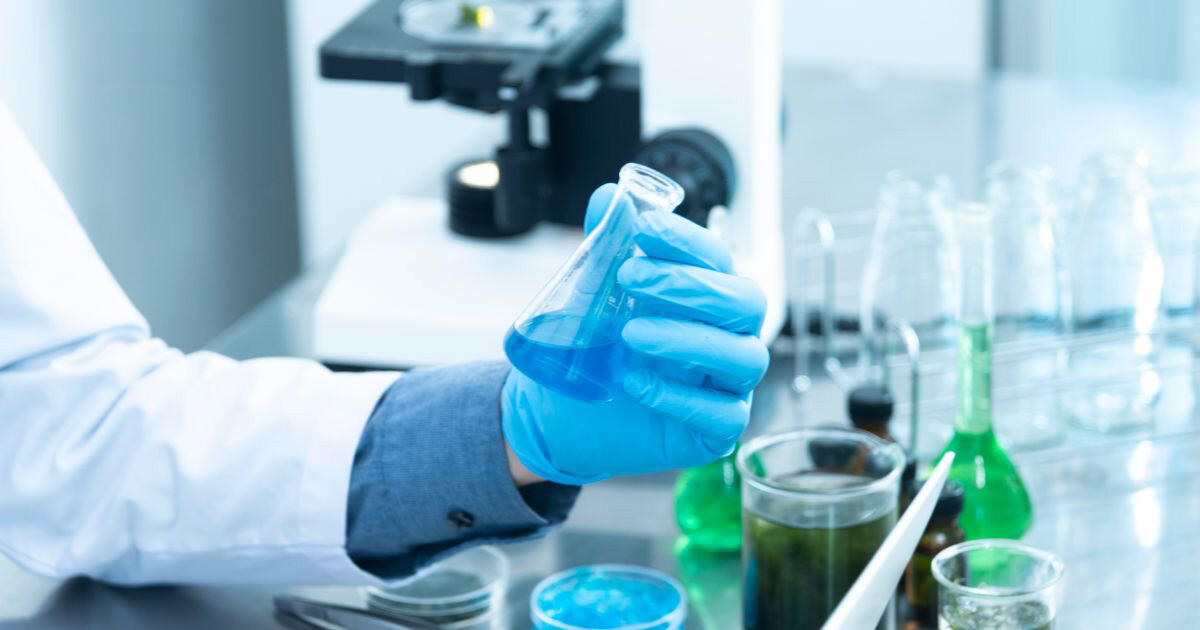 Scientist holding flask in hand