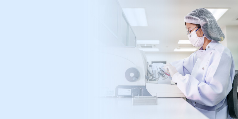 Scientist working with instruments at bench