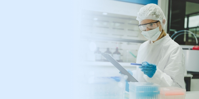 Scientist in protective gear examining checklist