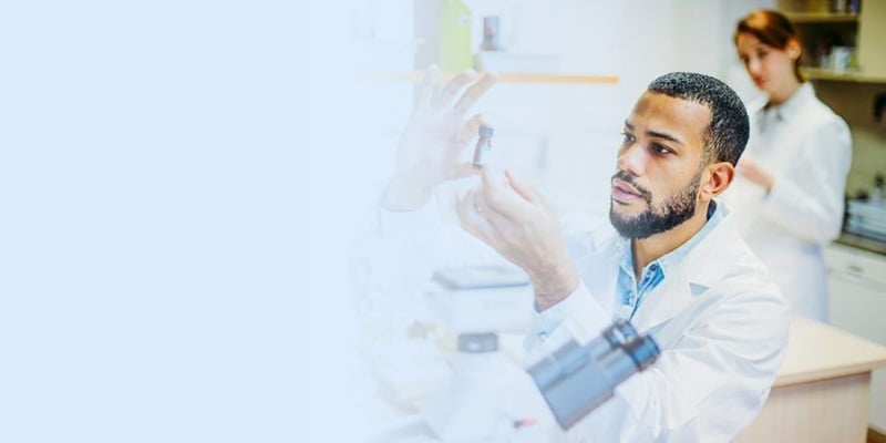 Scientist in lab examining DNA sequencing samples